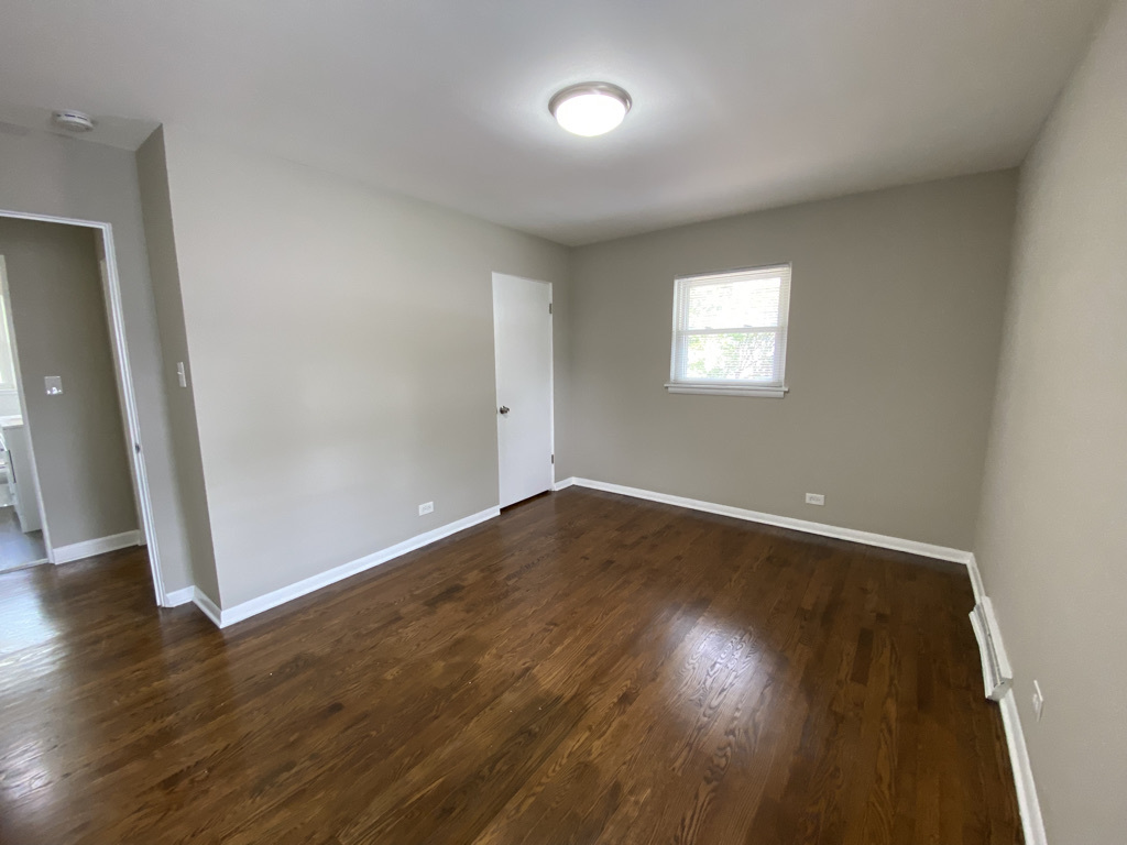201 Pine Street Villa Park, IL 60181 - Photo 10 of 17 an empty room with wooden floor and windows
