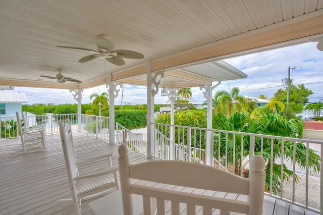 a view of a balcony with table and chairs