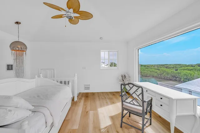 a bedroom with a bed and a chandelier