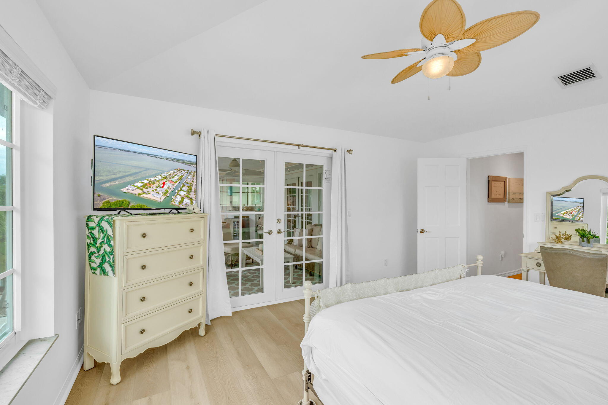 1147 Flagship Drive Summerland Key, FL 33042 - Photo 28 of 53 a bedroom with a bed and a chandelier