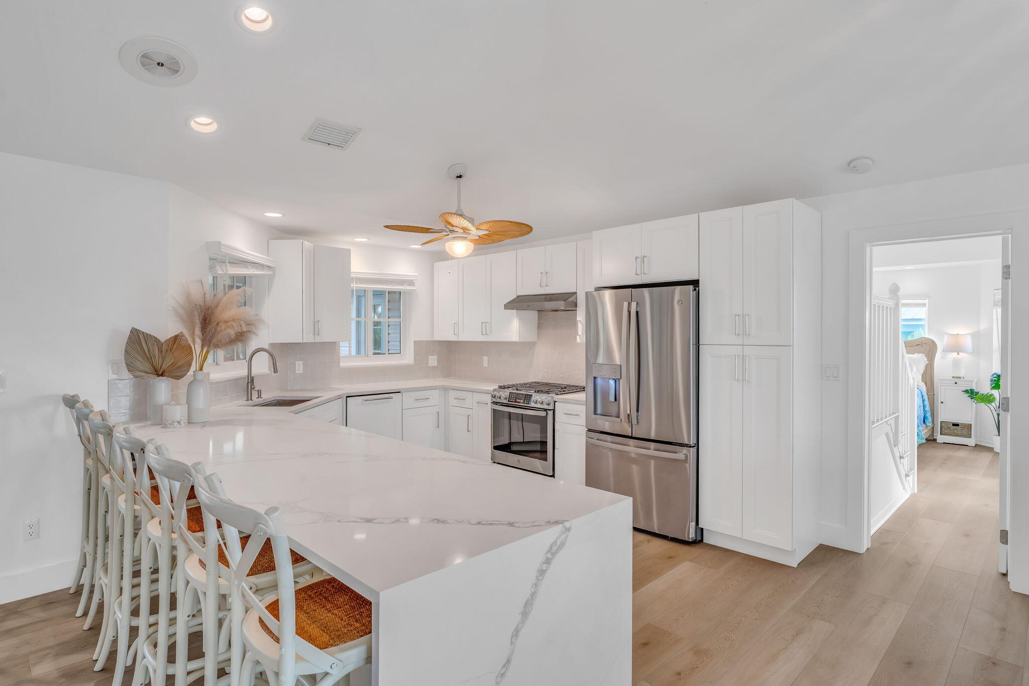 1147 Flagship Drive Summerland Key, FL 33042 - Photo 4 of 53 a kitchen with stainless steel appliances granite countertop a sink a stove a refrigerator and island with wooden floor