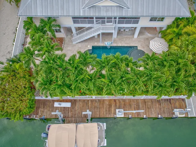 an aerial view of house with yard swimming pool and outdoor seating