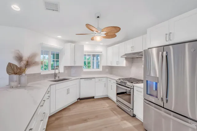 a kitchen with a sink stainless steel appliances and cabinets