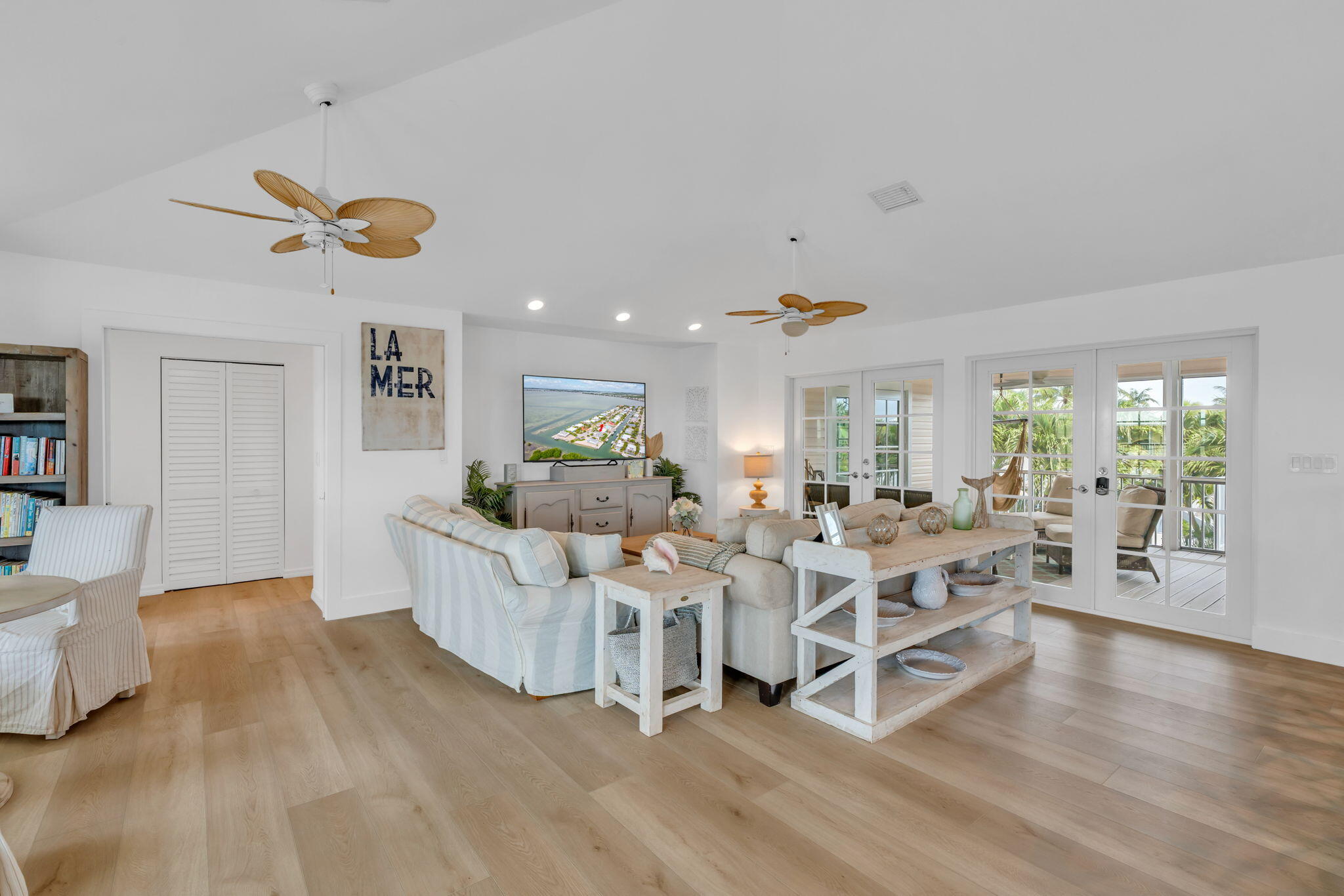 1147 Flagship Drive Summerland Key, FL 33042 - Photo 10 of 53 a living room with couches and kitchen view with wooden floor