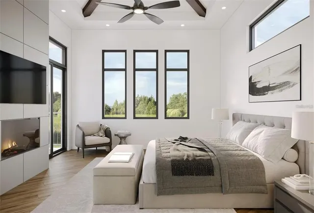 a bedroom with a bed a couch and a flat screen tv