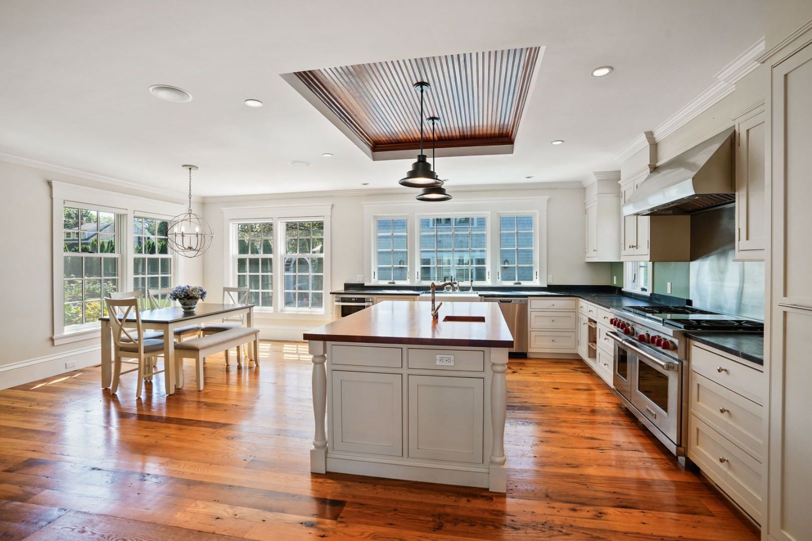 52 South Summer Street Edgartown, MA 02539 - Photo 15 of 51 an open kitchen with wooden floor and large windows