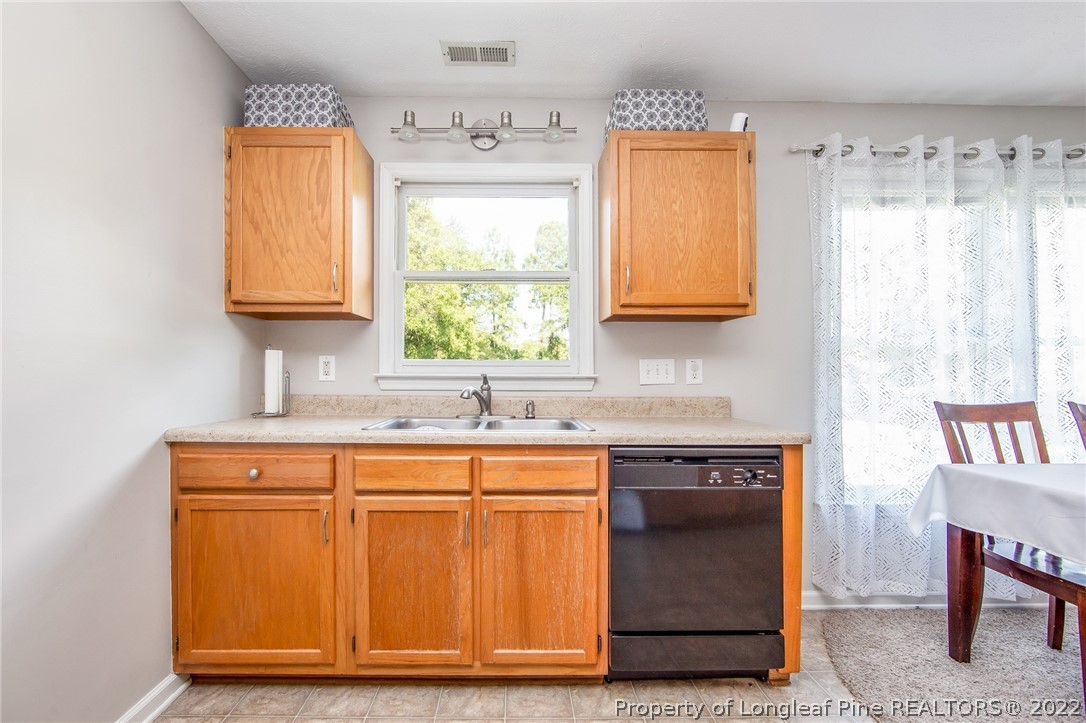 407 Kernstown Road Raeford, NC 28376 - Photo 17 of 35 a kitchen with cabinets and window