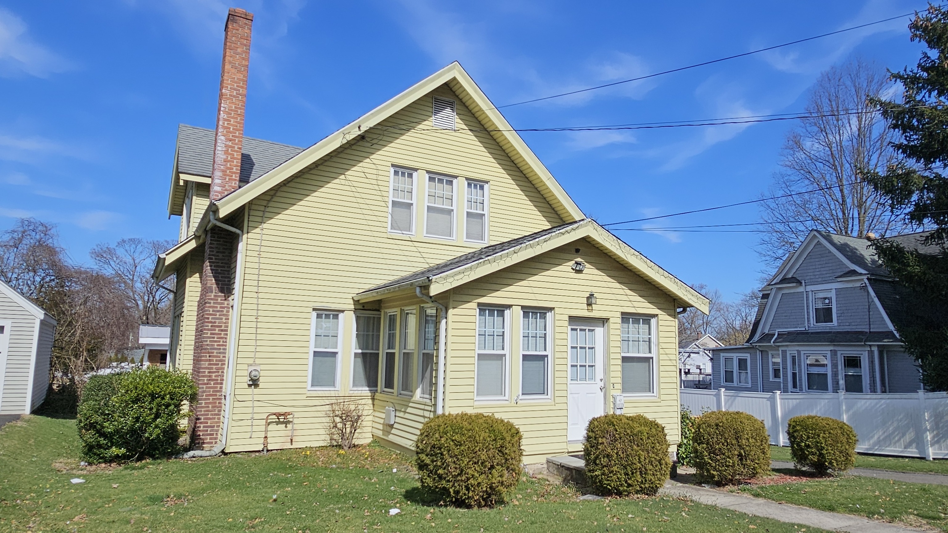 195 Toms Road Stamford, CT 06906 - Photo 1 of 1 a front view of a house with a yard