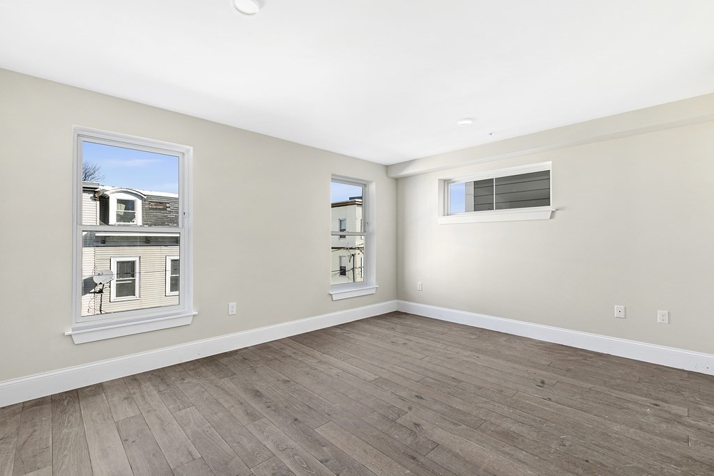 29 Ward Street, Unit 101 Boston, MA 02127 - Photo 11 of 11 a view of empty room with wooden floor and windows