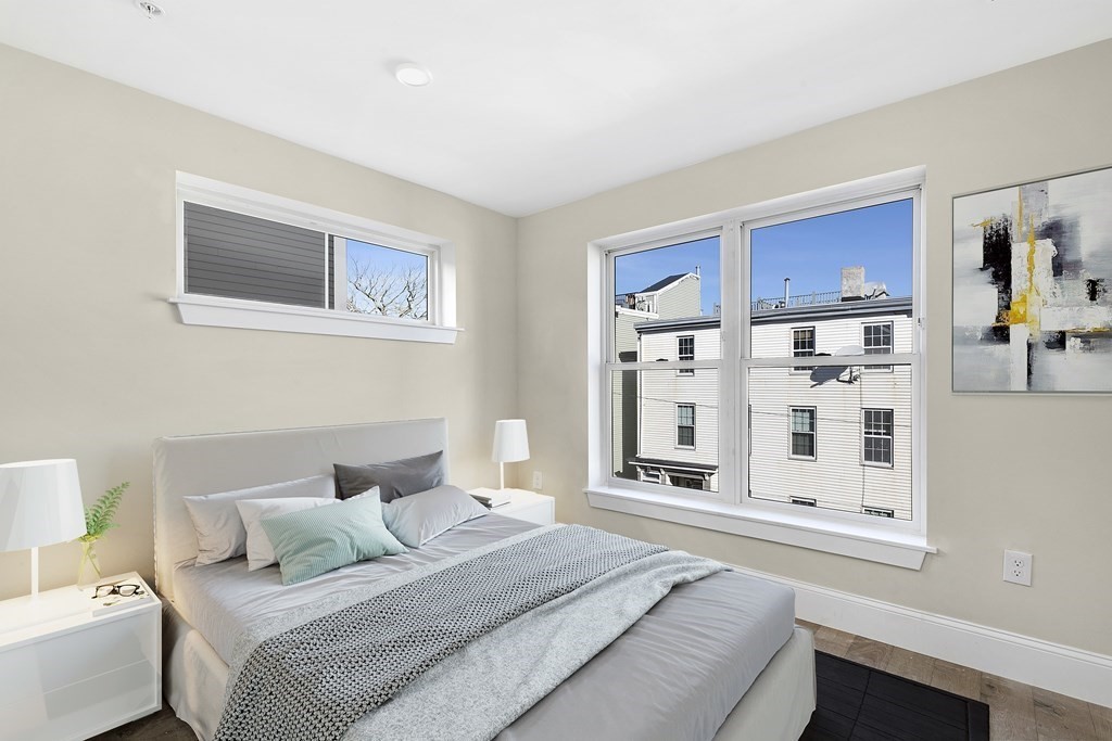 29 Ward Street, Unit 101 Boston, MA 02127 - Photo 2 of 11 a bedroom with a bed and a window