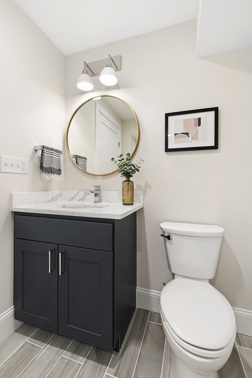 29 Ward Street, Unit 101 Boston, MA 02127 - Photo 8 of 11 a bathroom with a toilet sink and mirror