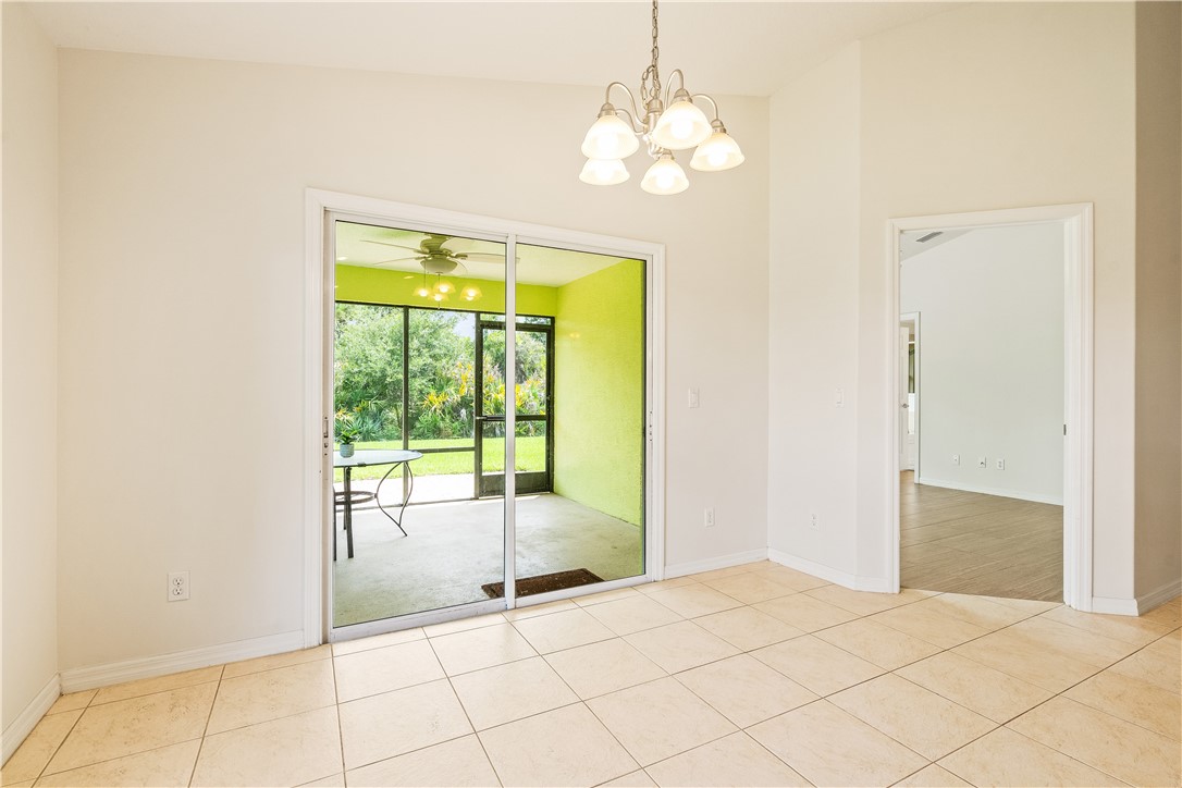 1087 4th Lane Southwest Vero Beach, FL 32962 - Photo 16 of 34 a view of an empty room with wooden floor and a window