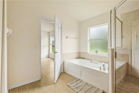 a bathroom with a tub shower and sink