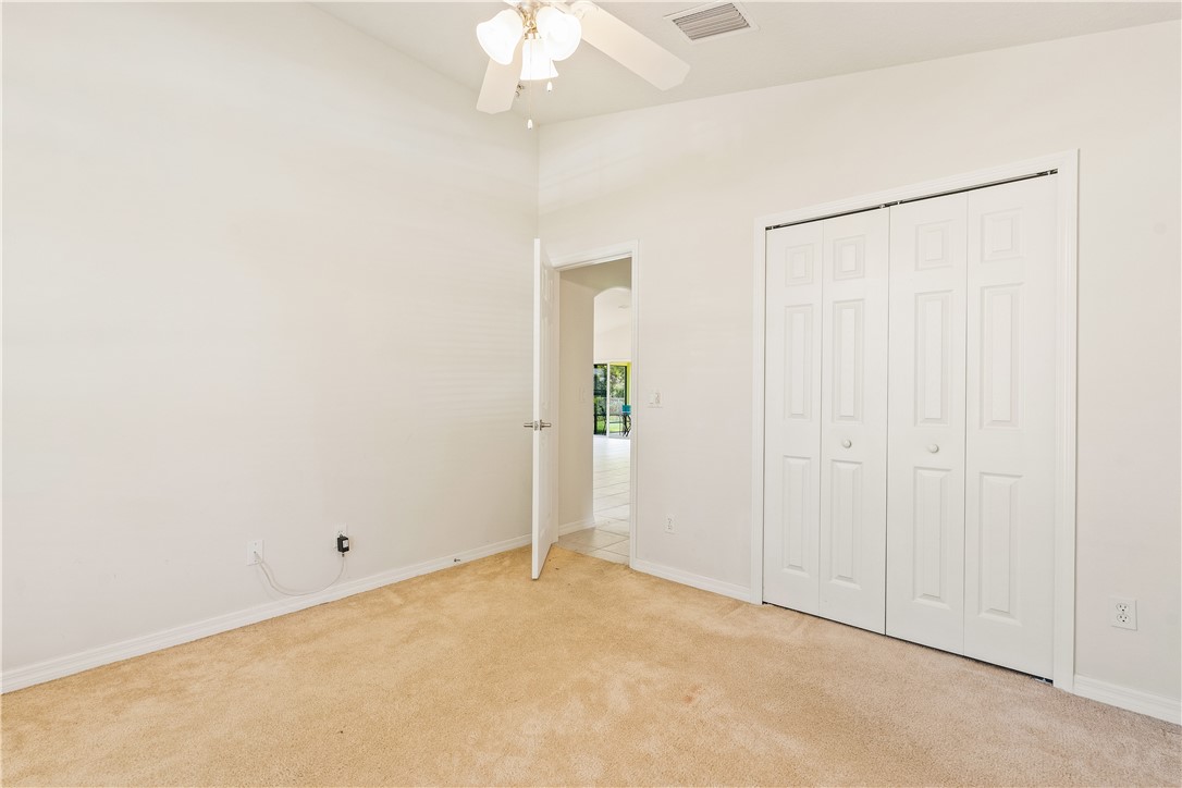 1087 4th Lane Southwest Vero Beach, FL 32962 - Photo 24 of 34 an empty room with a chandelier fan