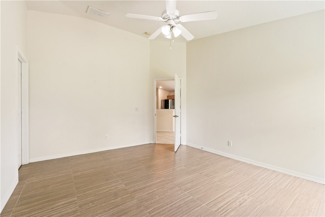 1087 4th Lane Southwest Vero Beach, FL 32962 - Photo 28 of 34 an empty room with wooden floor and ceiling fan