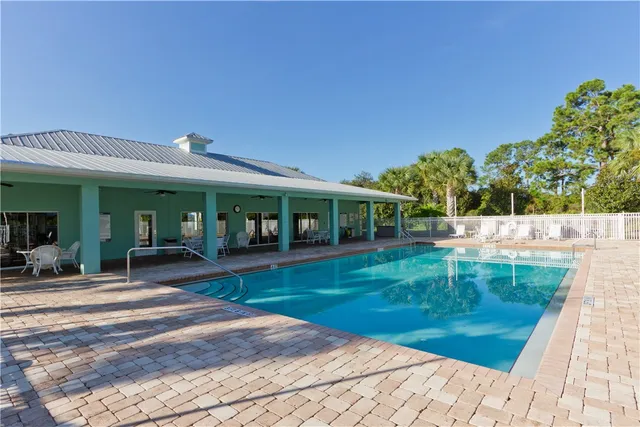 a view of a house with backyard porch and sitting area