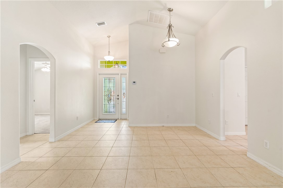 1087 4th Lane Southwest Vero Beach, FL 32962 - Photo 9 of 34 a view of an empty room with window and chandelier