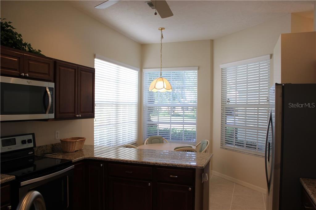 549 Fallbrook Drive Venice, FL 34292 - Photo 11 of 25 a kitchen with granite countertop sink stove and cabinets