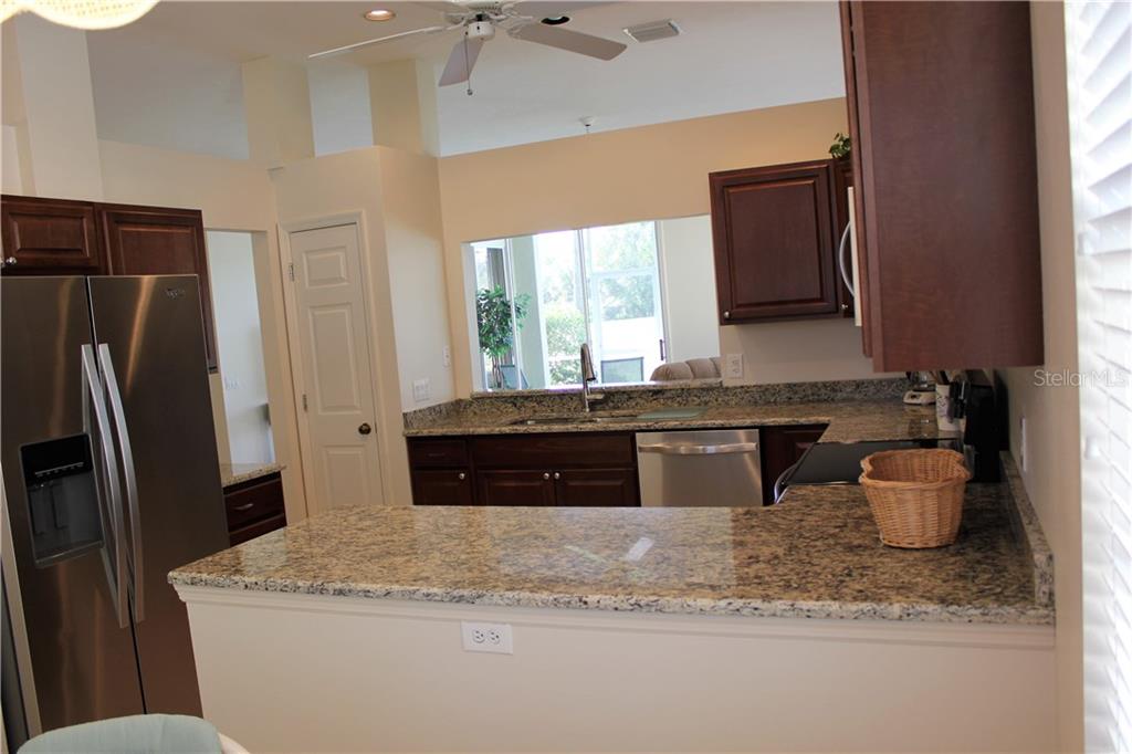 549 Fallbrook Drive Venice, FL 34292 - Photo 12 of 25 a kitchen with stainless steel appliances granite countertop a refrigerator a sink a stove and island