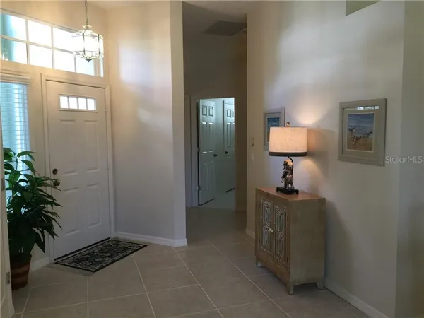 a bedroom with two beds and painting on the wall