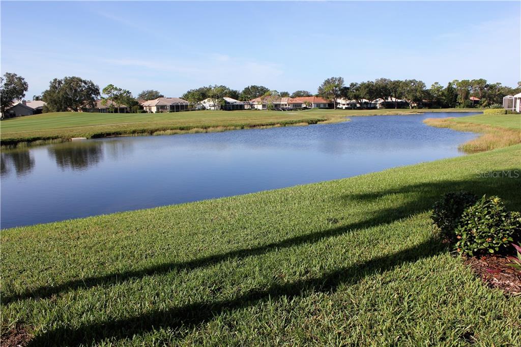 549 Fallbrook Drive Venice, FL 34292 - Photo 21 of 25 a view of a lake with houses in the back