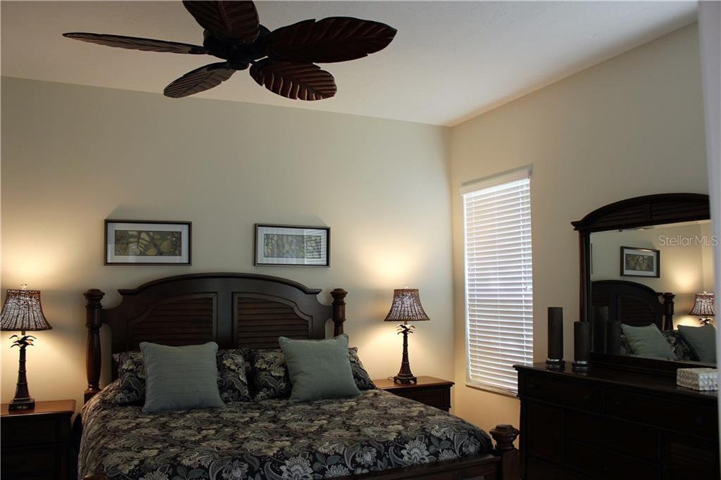 549 Fallbrook Drive Venice, FL 34292 - Photo 4 of 25 a bedroom with a bed and a chandelier