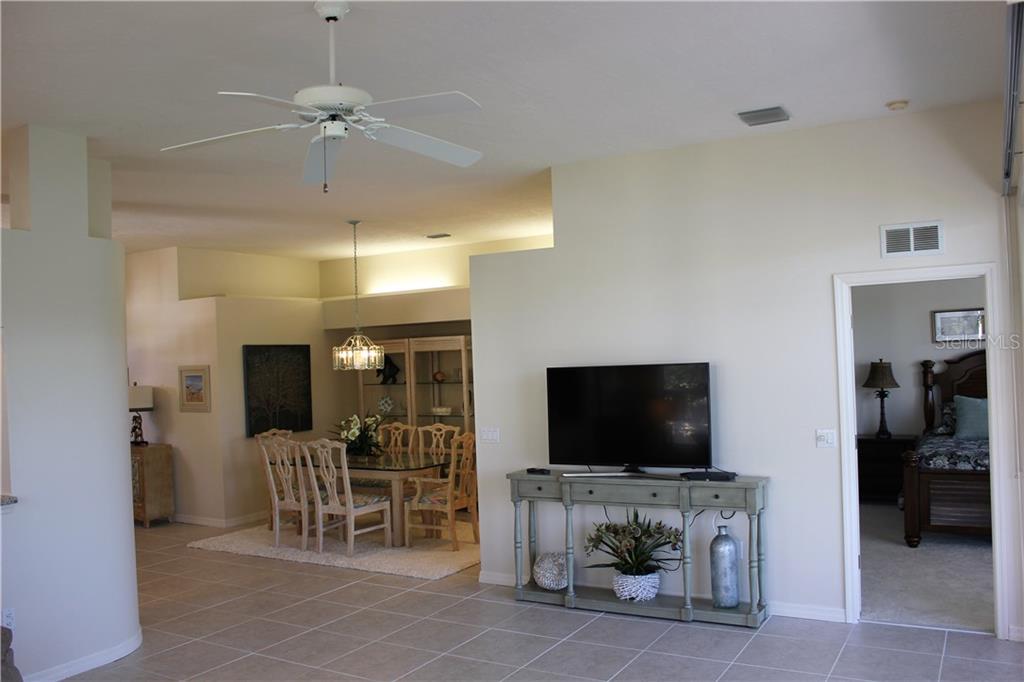 549 Fallbrook Drive Venice, FL 34292 - Photo 9 of 25 a living room with furniture and a flat screen tv