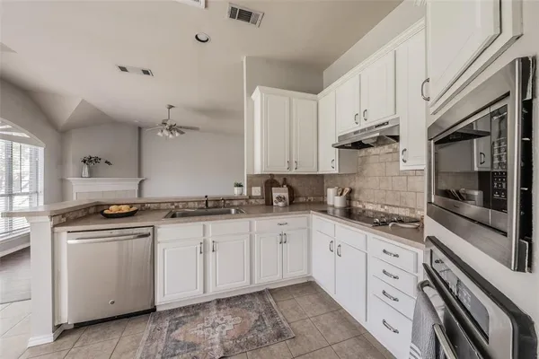 a kitchen with stainless steel appliances granite countertop a sink and cabinets