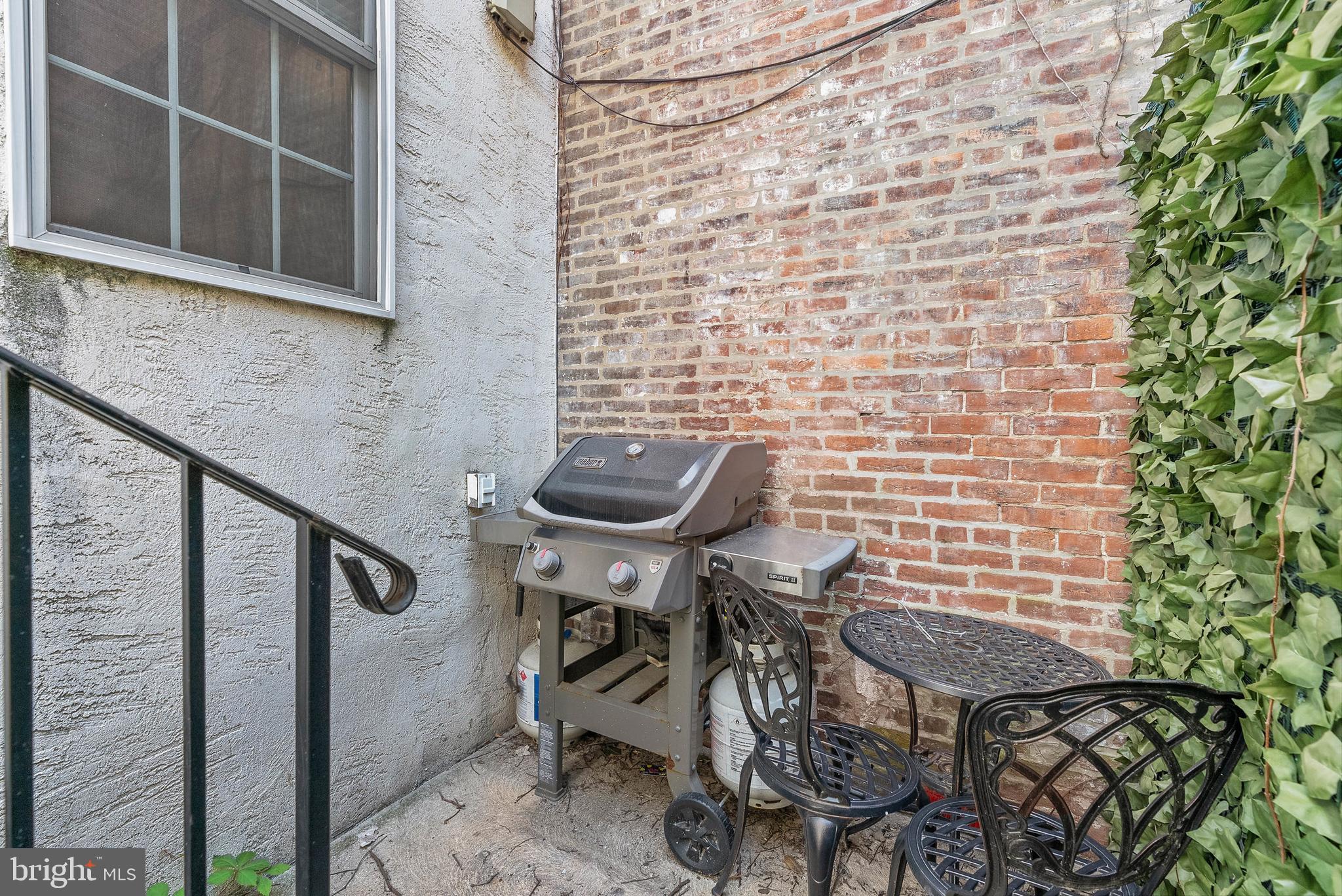 1522 Race Street, Unit 1 Philadelphia, PA 19102 - Photo 18 of 26 a balcony with table and chairs