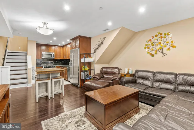 a living room with fireplace furniture and a wooden floor