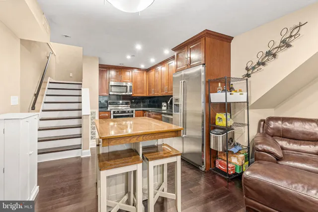 a dinning room with furniture and wooden floor