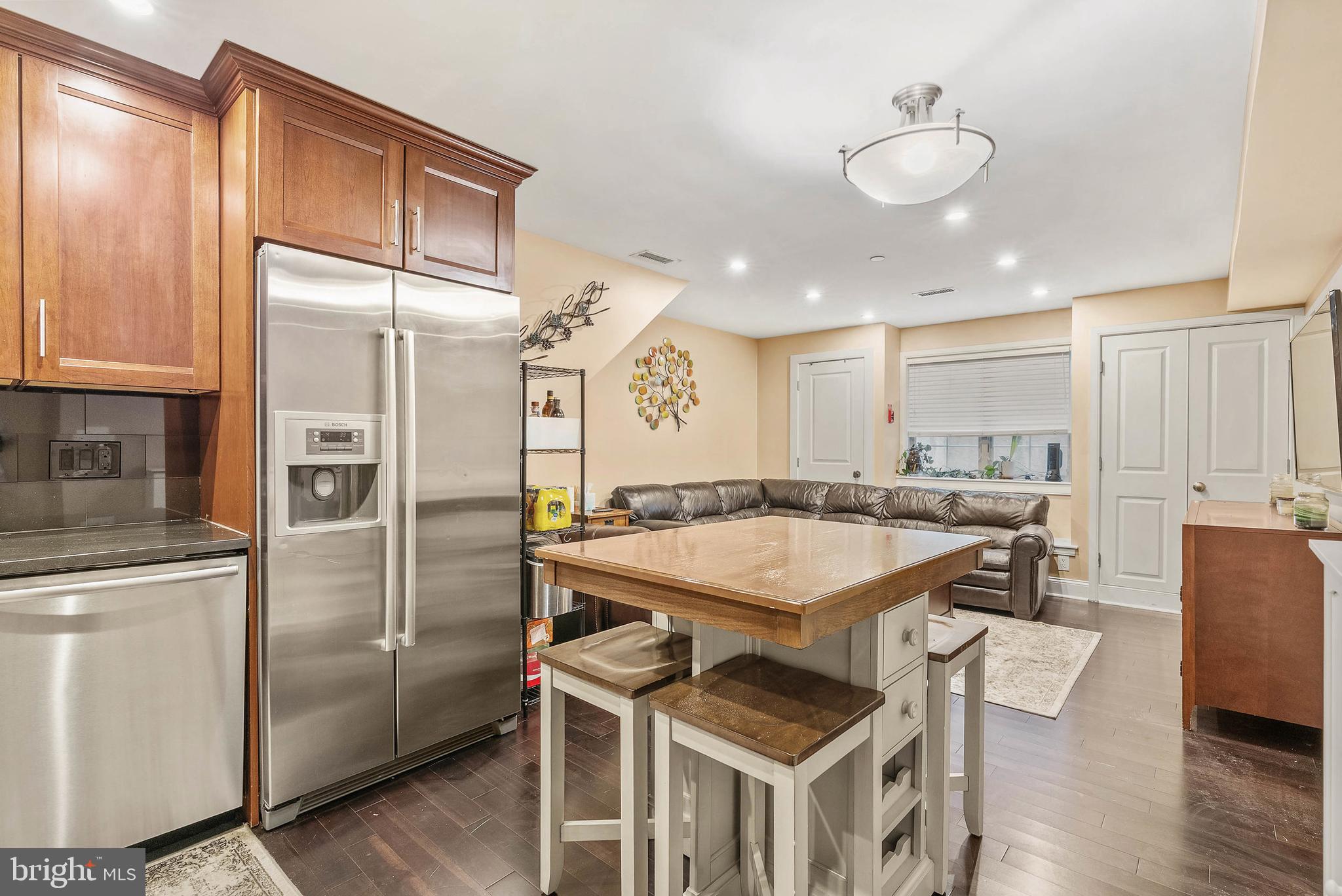 1522 Race Street, Unit 1 Philadelphia, PA 19102 - Photo 24 of 26 a kitchen with stainless steel appliances granite countertop a refrigerator a sink dishwasher and a stove with wooden floor
