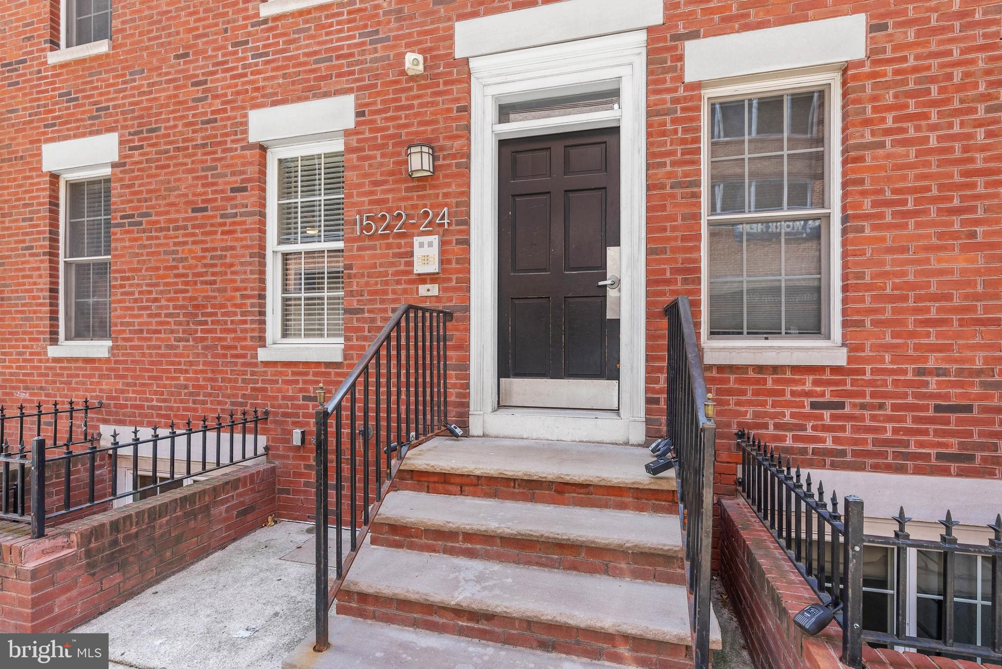 1522 Race Street, Unit 1 Philadelphia, PA 19102 - Photo 3 of 26 a view of a brick house with a window