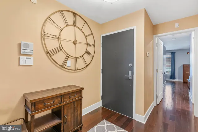 a view of a hallway with wooden floor and entryway