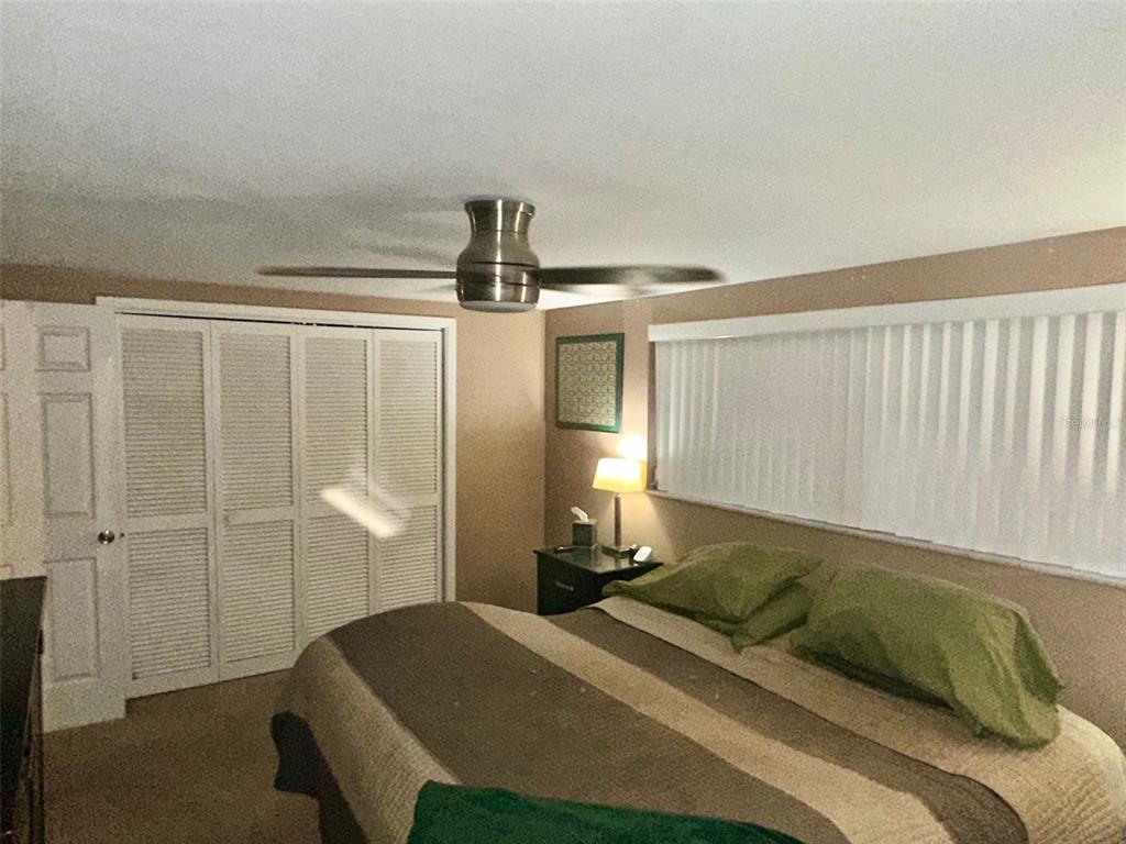 5245 Bluejay Drive Holiday, FL 34690 - Photo 11 of 18 a bedroom with a bed and a painting on the wall