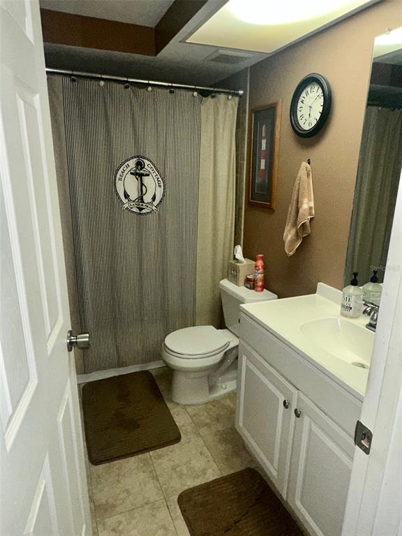 5245 Bluejay Drive Holiday, FL 34690 - Photo 13 of 18 a bathroom with a sink a toilet a mirror and shower