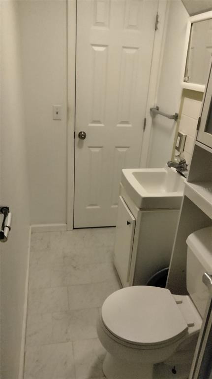 5245 Bluejay Drive Holiday, FL 34690 - Photo 10 of 18 a white toilet sitting next to a bathroom sink