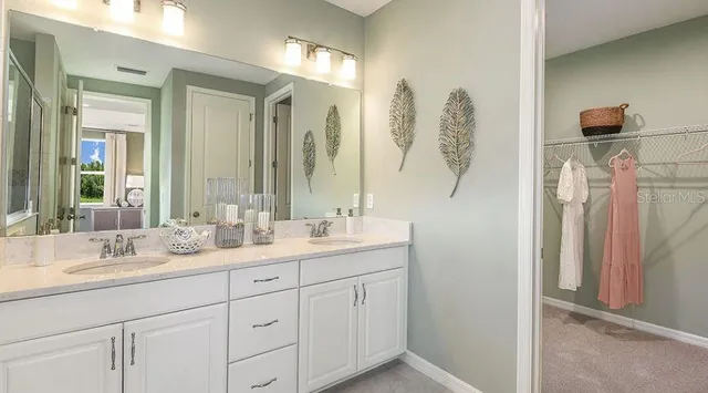 a bathroom with a double vanity sink and mirror