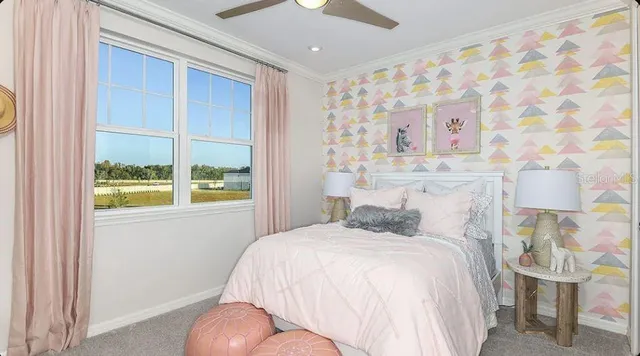 a bedroom with a bed and painting on the wall