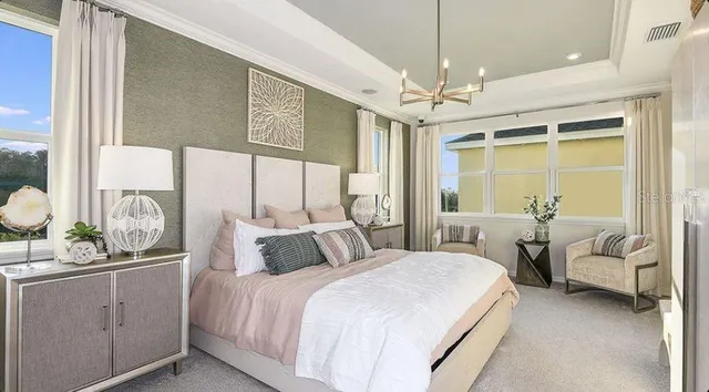 a bedroom with a bed and a chandelier