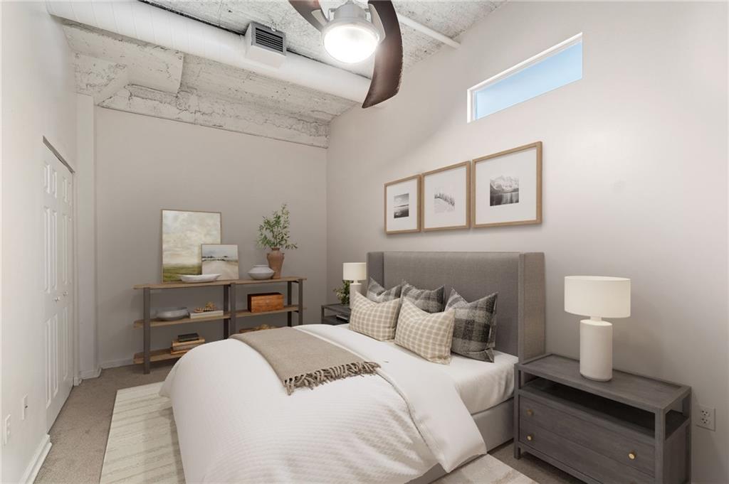 2434 Smallman Street, Unit 416 Pittsburgh, PA 15222 - Photo 8 of 31 a bedroom with a bed and a lamp on the dresser