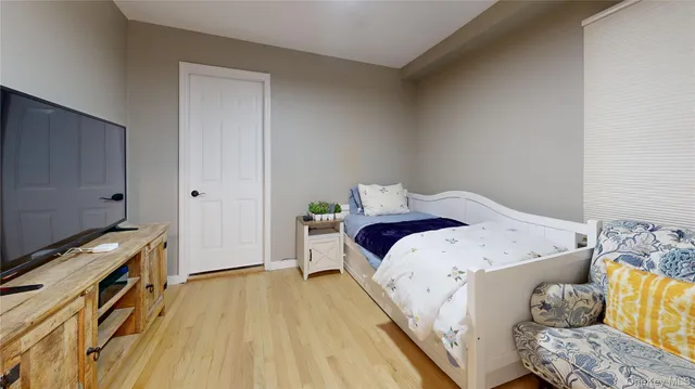 a view of bedroom with natural light and wooden floor