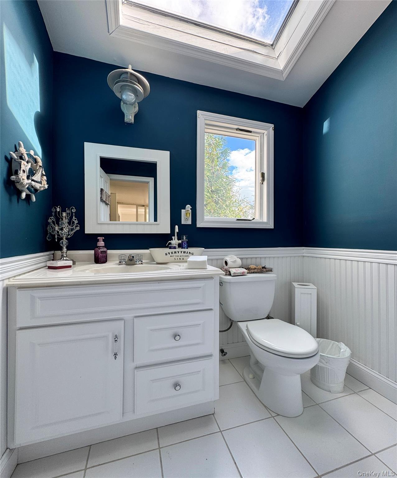 137 South Road Westhampton, NY 11977 - Photo 18 of 43 a bathroom with a toilet sink and mirror