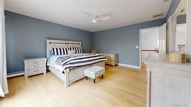 a spacious bedroom with a bed and a table in it