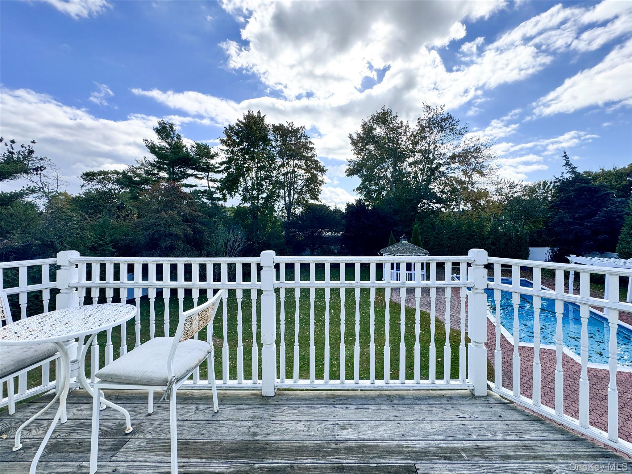137 South Road Westhampton, NY 11977 - Photo 23 of 43 a view of a chair and table on the wooden floor