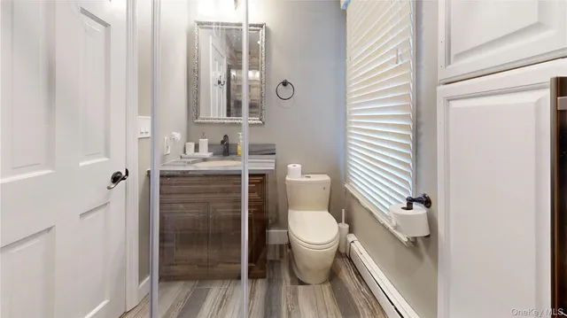 a bathroom with a toilet sink and a mirror