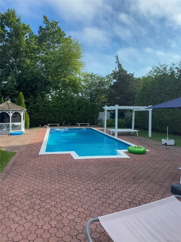a view of a swimming pool with a yard