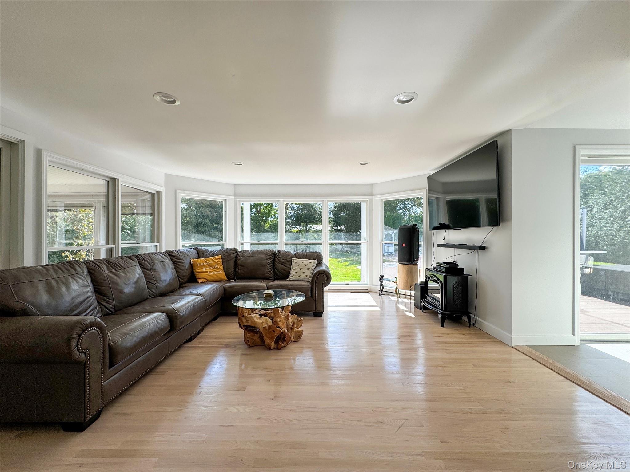 137 South Road Westhampton, NY 11977 - Photo 5 of 43 a living room with furniture and a flat screen tv