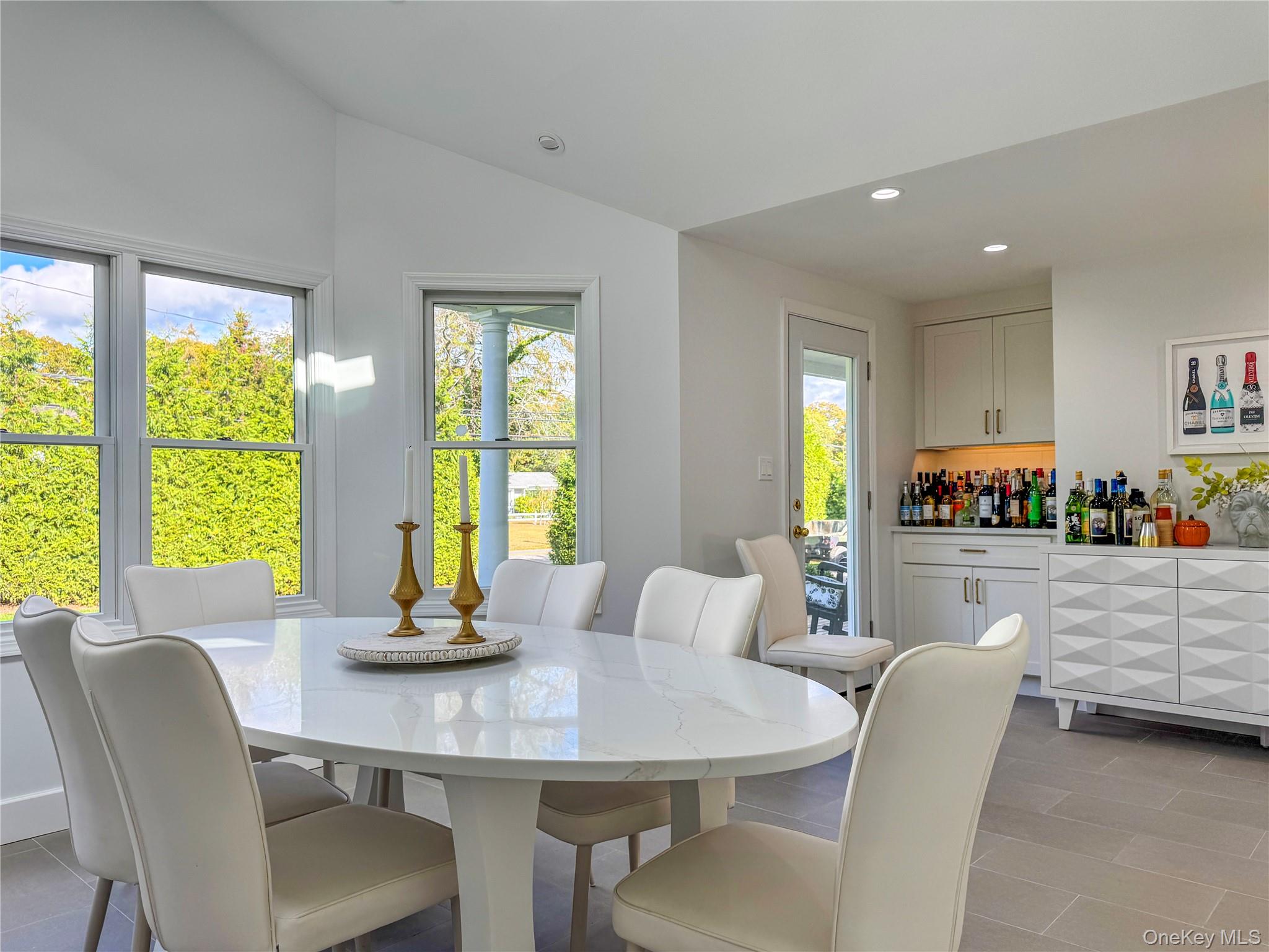 137 South Road Westhampton, NY 11977 - Photo 9 of 43 a dining room with furniture a large window and a chandelier