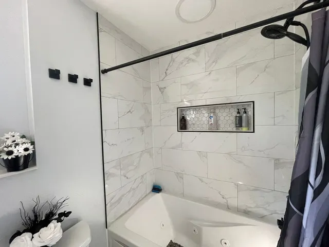 a bathroom with a bathtub and shower